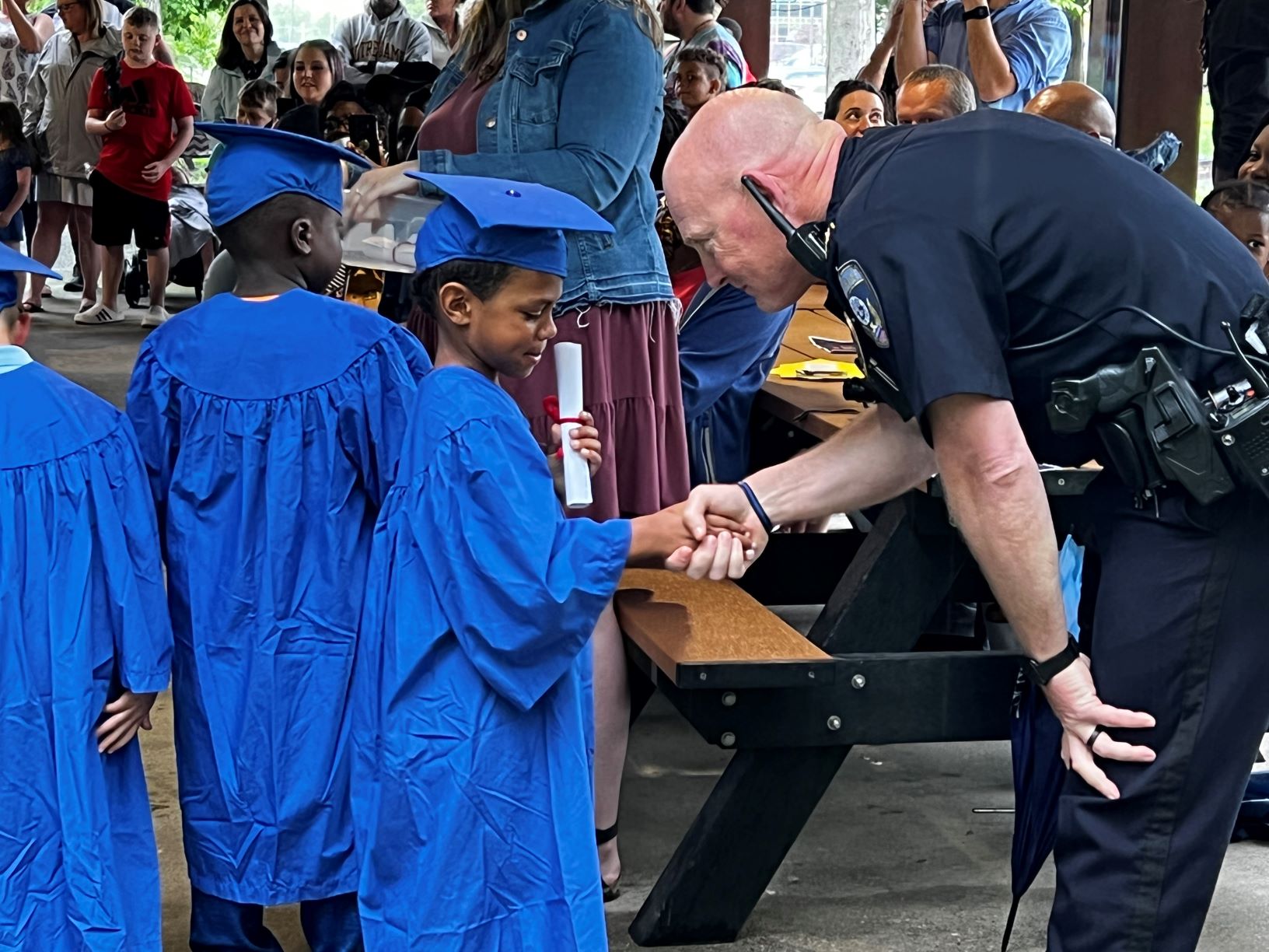 child receives diploma from chief